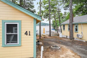 A yellow building with the number 41, a dock, and a lake in the background. - Cabin 41 at The Historic Sandy Point Resort w/ Boat Slip and Onsite Boat ramp (Alton)