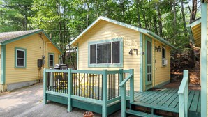 A cabin with a porch, a window with blinds, and a number '47' on the door. - Cabin 47 at Historic Sandy Point Resort W/ Boat Slip And Onsite Boat ramp (Alton)