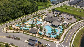 A resort with multiple swimming pools, a parking area, and a road. - Storey Lake: Cozy 2BR Near Disney (Kissimmee)