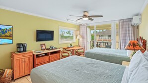 A hotel room with two beds, a desk, a coffee maker, a TV, and a balcony with a view. - New***Islander on the Beach 315-Top Floor Corner Mountain View with AC Sleeps 4 (Kapaa)