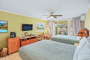 A hotel room with two beds, a desk, a coffee maker, a TV, and a balcony with a view. - New***Islander on the Beach 315-Top Floor Corner Mountain View with AC Sleeps 4 (Kapaa)