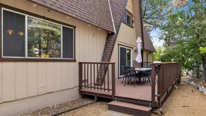 A house with a deck, a patio table, and outdoor seating. - Mountain Getaway Near Snow Summit | 4BR • 3.5BA • Game Room (Big Bear Lake)
