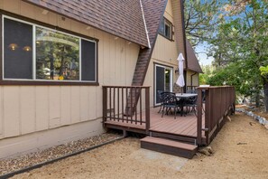 A house with a deck, a patio table, and outdoor seating. - Mountain Getaway Near Snow Summit | 4BR • 3.5BA • Game Room (Big Bear Lake)