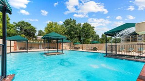 A swimming pool with multiple gazebos and lounge chairs. - Branson 2BR Condo | Family Escape | Sleeps 6 (Branson)