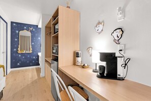 A modern kitchen with a built-in refrigerator, a coffee machine, and a microwave. - Beauty and the Beast Room Near Disney (Kissimmee)