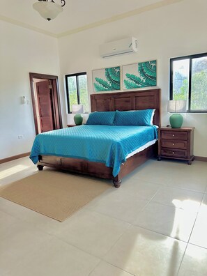 A bedroom with a bed, a nightstand, a window, and a door. - Spacious 12 Bedrooms Villa for Large Groups in St Ann, Jamaica (Saint Ann's Bay)