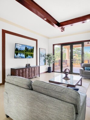 A living room with a sofa, a coffee table, a TV, and a cabinet. - Spacious 12 Bedrooms Villa for Large Groups in St Ann, Jamaica (Saint Ann's Bay)