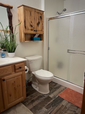 Shower, hair dryer, towels, soap - Cabin retreat featuring vaulted ceilings and a covered deck with stone fireplace (Overgaard)