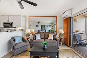 A modern living room with a sofa set, a coffee table, and a dining area in the background. - New Listing! My Perfect Stays! (Lahaina)