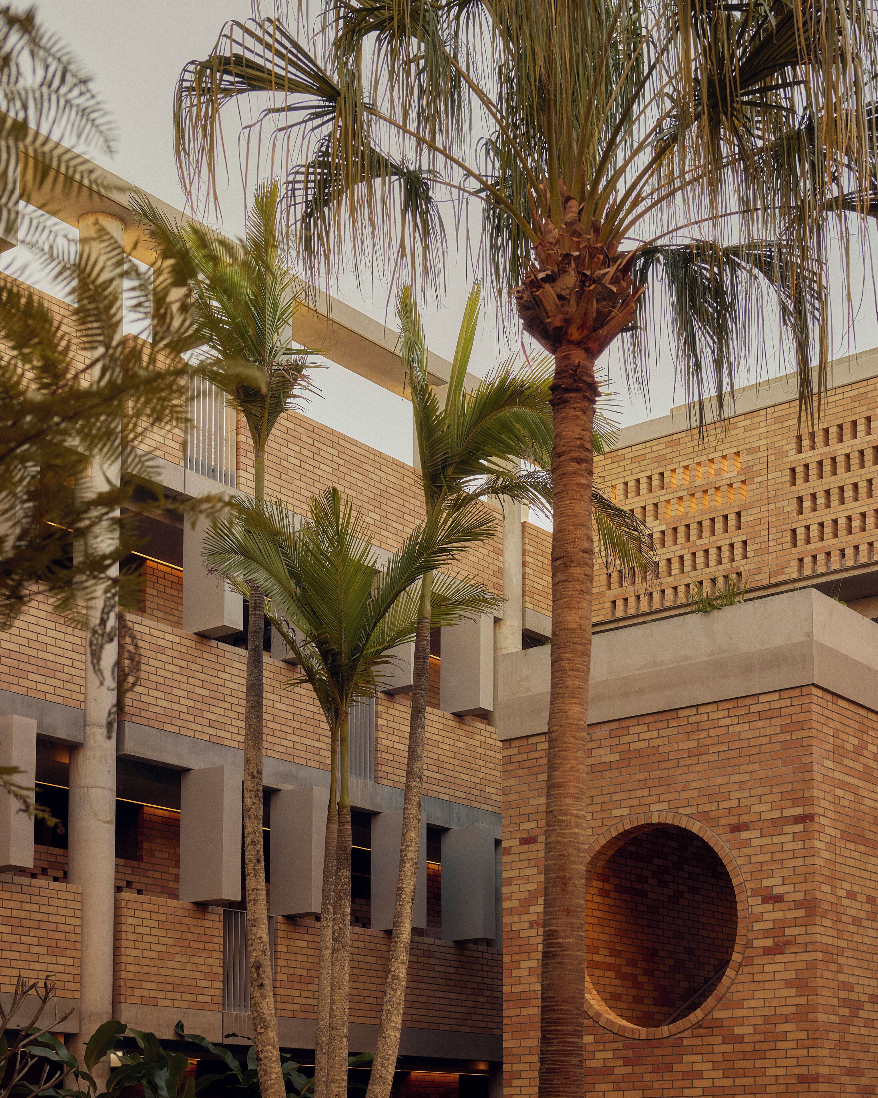 A building with a brick facade, multiple floors, and a circular window.