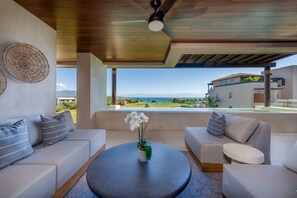 A modern living room with a view of the ocean and a golf course. - Condo Sardan 3BD - Tau Punta Mita (Punta de Mita)