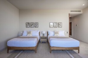 A double room with two beds, a small bedside table with a lamp, and a wall-mounted air vent. - Penthouse Arenamar 4BD - Surf Punta Mita (Punta de Mita)