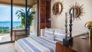 A bedroom with a large bed, a view of the sea, and a balcony with plants. - Casa Escrita 3BD - Tau Punta Mita (Punta de Mita)