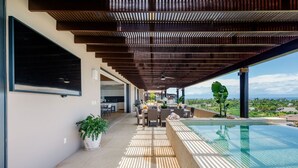 A covered outdoor area with a pool, dining setup, and a view of the landscape. - Vista Ballena 4BD - Tau Punta Mita (Punta de Mita)