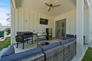 A covered patio with a grill, refrigerator, and seating area. - Sandbar Drift - Where the Coast Slows Down. (Laguna Beach)