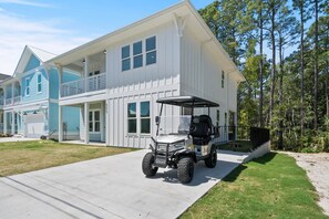 A two-story house with a covered porch and a golf cart parked in front. - Sandbar Drift - Where the Coast Slows Down. (Laguna Beach)