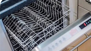 A dishwasher with a control panel and a rack inside. - Salford Serenity - Modern 2 Bedroom Apartment (Salford)