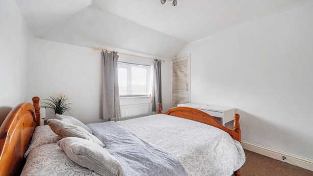 A bedroom with a single bed, a bedside table, a radiator, a window with curtains, and a ceiling fan. - 3 Bed - Sleeps 6 - Parking - Central Canterbury (Canterbury)