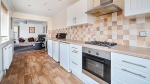 A modern kitchen with white cabinetry, a tiled backsplash, a gas stove, and a built-in oven. - 3 Bed - Sleeps 6 - Parking - Central Canterbury (Canterbury)