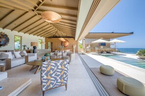 A modern interior with a pool, outdoor seating, and a view of the sea. - Casa Yeiy 7BD - Kupuri Punta Mita (Punta de Mita)