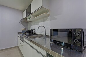 A modern kitchen with stainless steel appliances, a built-in oven, and a sink. - The 1 Bedroom "Two" Apartment Pratumnak - Olympic Pool #Room2 (Muang Pattaya)