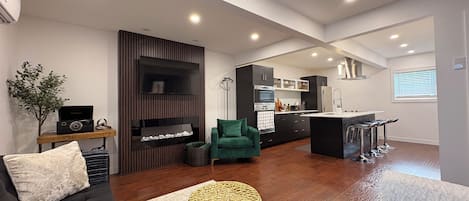 A modern living room with a sofa, a green armchair, and a coffee table.