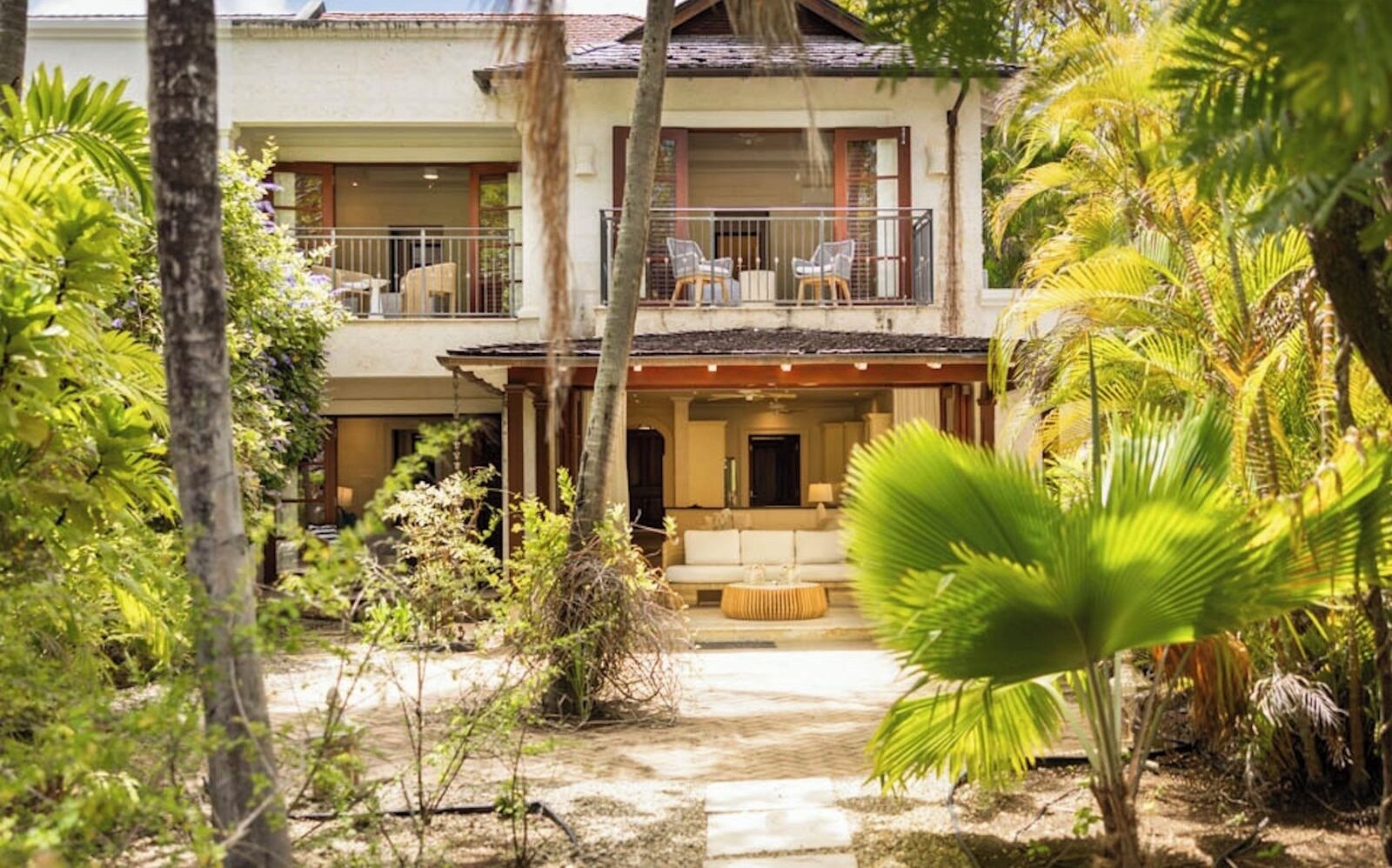 A two-story building with a balcony and outdoor seating area.