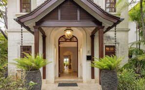 A building entrance with a covered porch, a central light fixture, and a number '5' sign. - Claridges 5 - 3bd by Zenbreak (Gibbes)