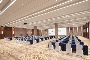 A conference room with rows of tables and chairs, a projector, and a screen with text. - Baoding Hotel of HangzhouGrandNewCentury (Hangzhou)