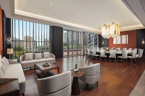 A spacious hotel lobby with a dining area, large windows offering city views, and modern decor. - Baoding Hotel of HangzhouGrandNewCentury (Hangzhou)