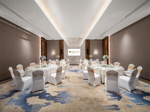 A conference room with round tables, white chairs, and a carpeted floor. - Baoding Hotel of HangzhouGrandNewCentury (Hangzhou)