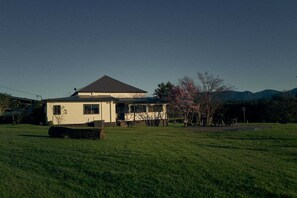 A single-story house with a sloped roof, a front porch, and a well-maintained lawn.