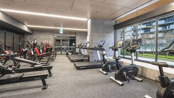 A gym with treadmills, stationary bikes, and weight machines.