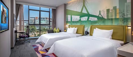 A hotel room with two beds, a desk, a chair, and a large window with a city view.