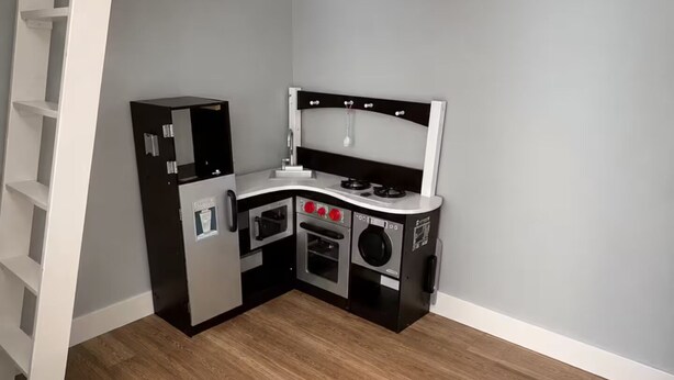 A compact kitchen with a refrigerator, oven, microwave, and sink. - Spacious Family Retreat Near Ann Arbor & U-M (Ypsilanti)