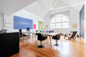 A spacious conference room with a high ceiling, a large window, and a modern design. - Hoffman Square - Two Bedroom Apartment, Sleeps 4 (London)