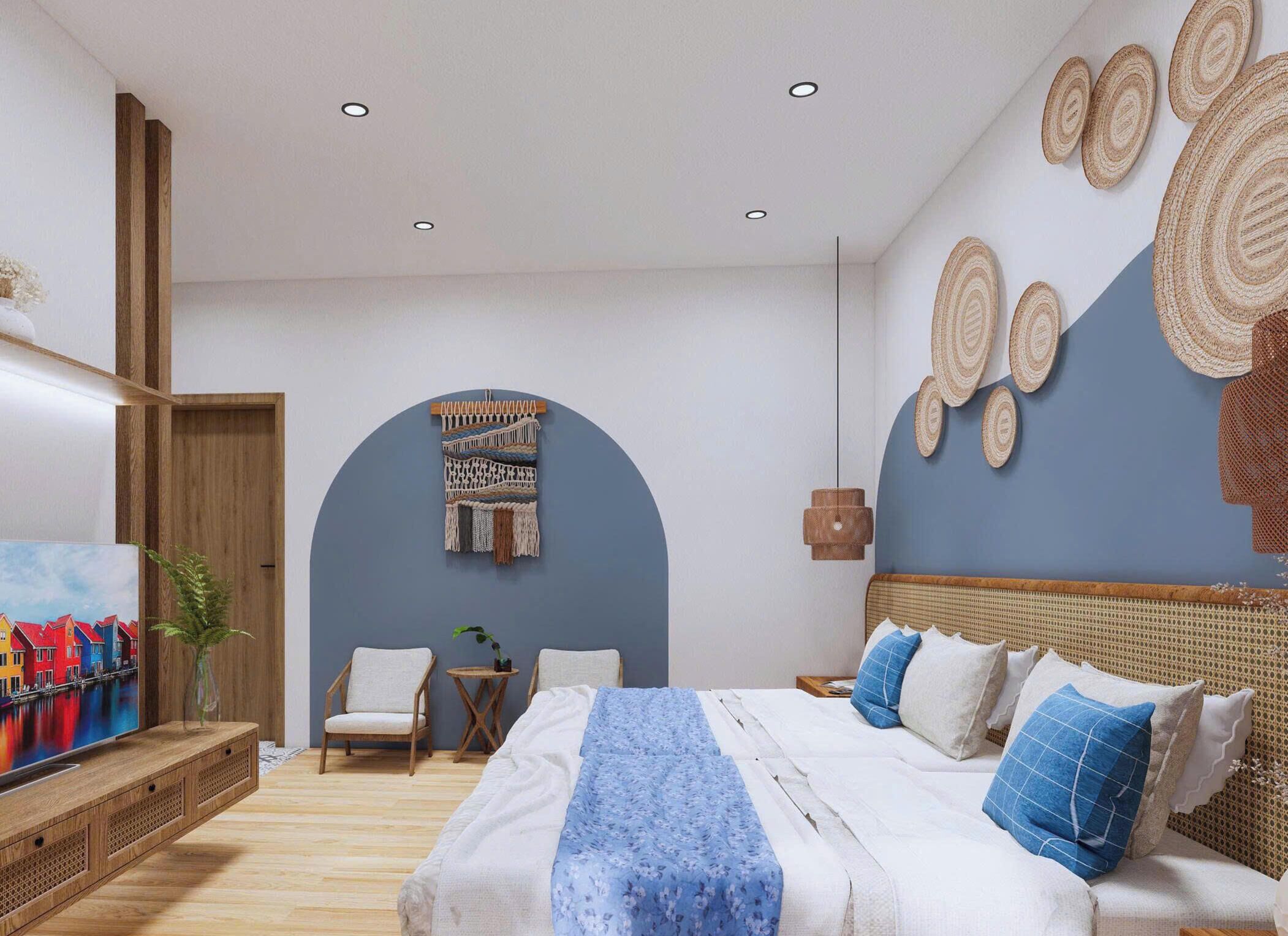 A modern bedroom with a bed, chairs, a painting, and wall decor.