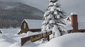 A snow-covered landscape with a wooden sign for Redburn Ranch. - Dolores River "BIG House" 8BR Cabin 300-Acre Private Ranch (Dolores)