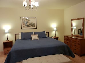 A bedroom with a large bed, two bedside tables with lamps, a dresser, a mirror, and a framed picture on the wall. - Dolores River "BIG House" 8BR Cabin 300-Acre Private Ranch (Dolores)