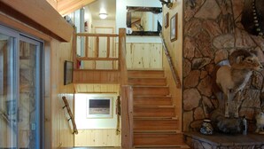 A wooden staircase with a stone wall and a ram head decoration. - Dolores River "BIG House" 8BR Cabin 300-Acre Private Ranch (Dolores)