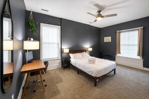 A bedroom with a bed, desk, chair, and a ceiling fan. - King 1BR Opposite SLU Hospital Balcony  Parking (St. Louis)