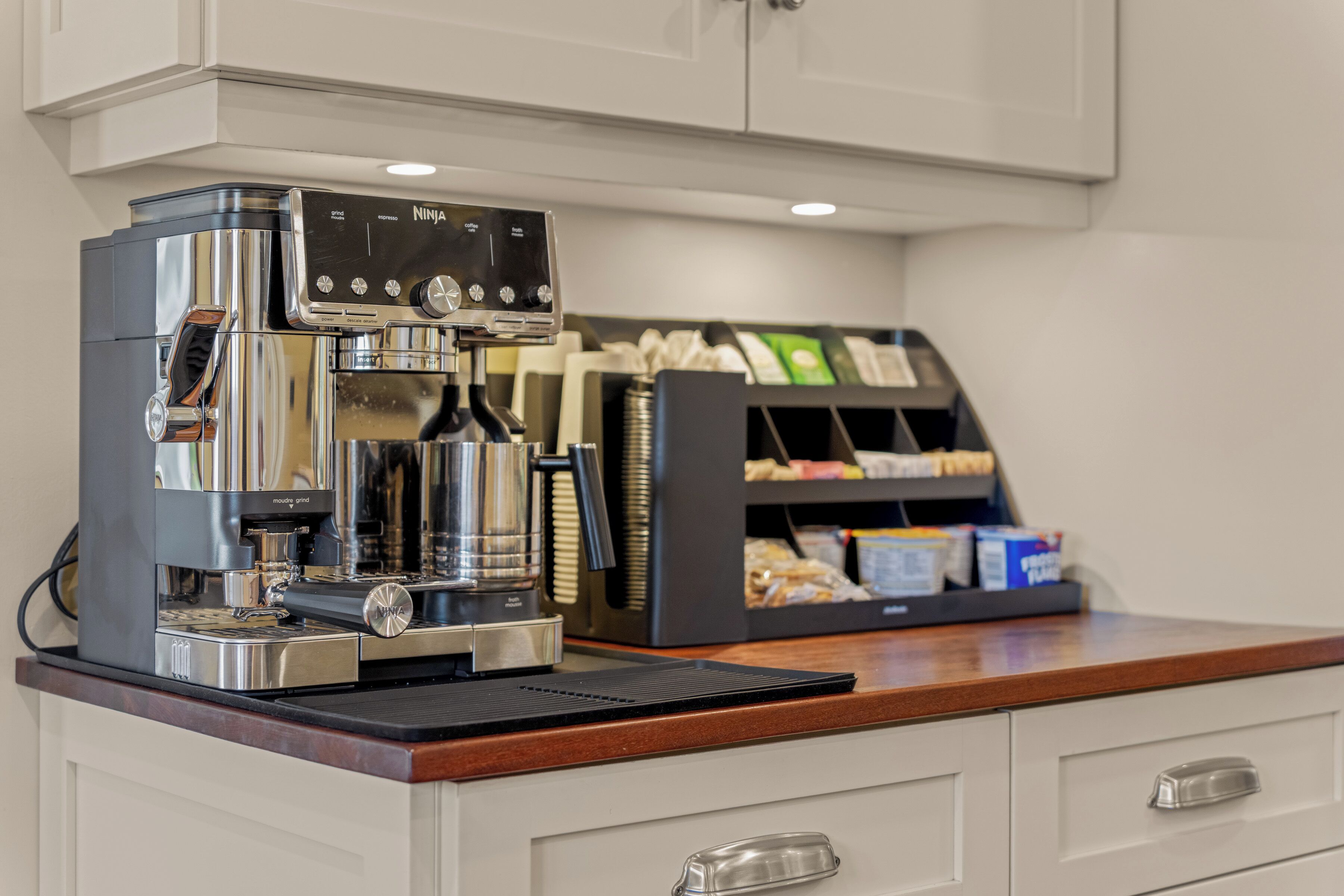 A coffee machine with a control panel and a coffee pod display.