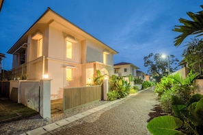 A two-story residential building with a paved driveway and a gated entrance. - Staymaster Villa Zelora - 4BR with Pool  (Siolim)