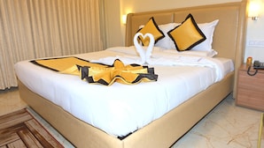 A hotel room with a bed, a nightstand, a lamp, and a telephone.