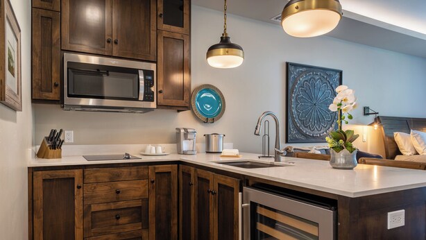 A modern kitchen with wooden cabinets, stainless steel appliances, and a central island. - 4 Suites + Balconies | Steps to DT Square | Paso Park Suites Buyout (Paso Robles)