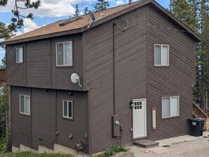 A two-story building with a brown exterior, a satellite dish, and a welcome sign. - Mountain View Retreat | Game Room & Fireplace (Fairplay)