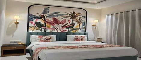 A bedroom with a bed, nightstands, a wall-mounted lamp, and a ceiling fan.
