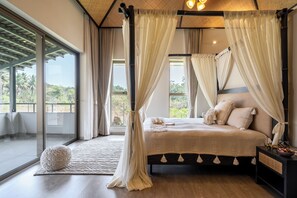 Un dormitorio con cama con dosel, ventanas amplias y vistas al exterior.