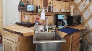 A compact kitchen with a sink, a coffee maker, and a microwave. - A tranquil yurt with all the amenities in charming Big Lake (Big Lake)