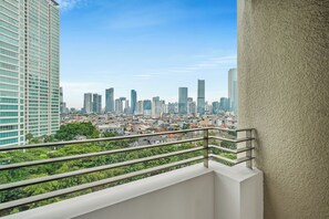 A cityscape with high-rise buildings and a balcony railing. - Nevora by Kozystay - Kuningan (Jakarta Selatan)